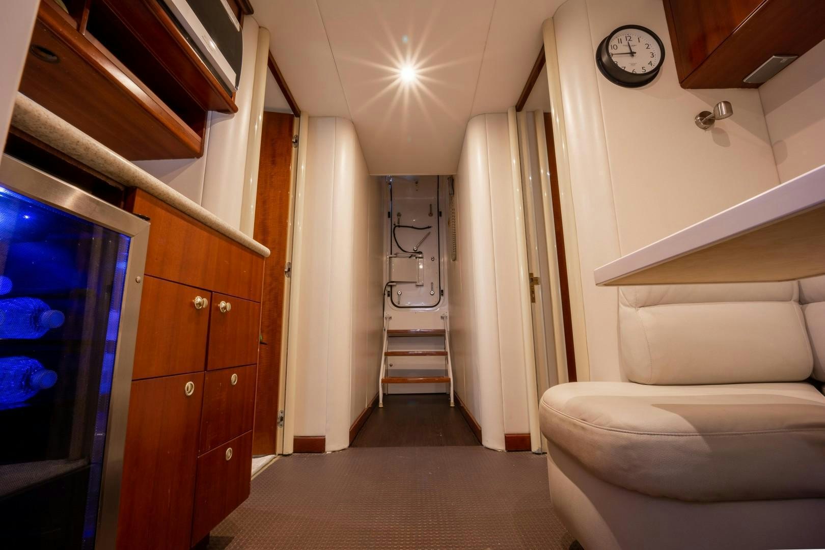 a room with a staircase and a clock on the wall aboard PASSION Yacht for Sale