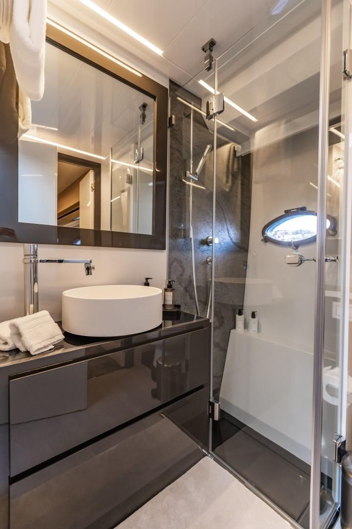 a bathroom with a glass shower aboard Q80 Yacht for Sale