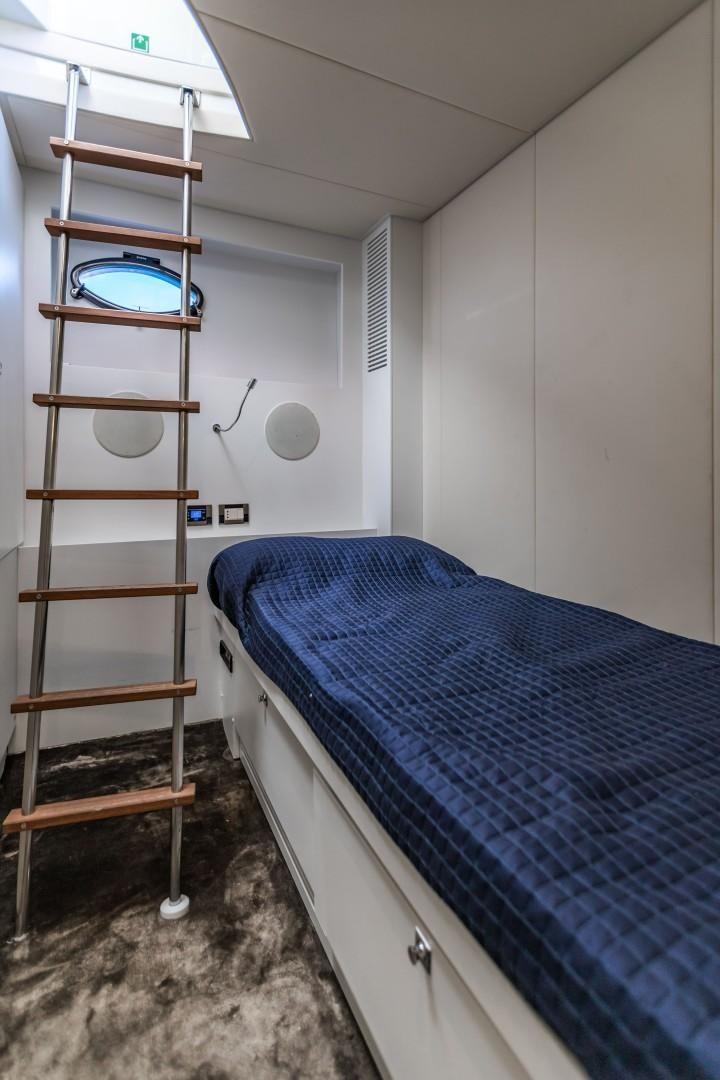 a bed and a ladder in a room aboard Q80 Yacht for Sale