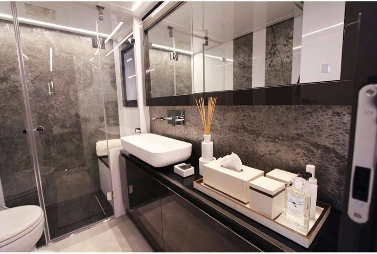 a bathroom with a glass shower aboard Q80 Yacht for Sale