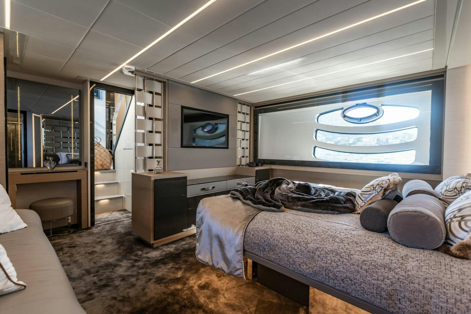 a bedroom with a large screen aboard Q80 Yacht for Sale