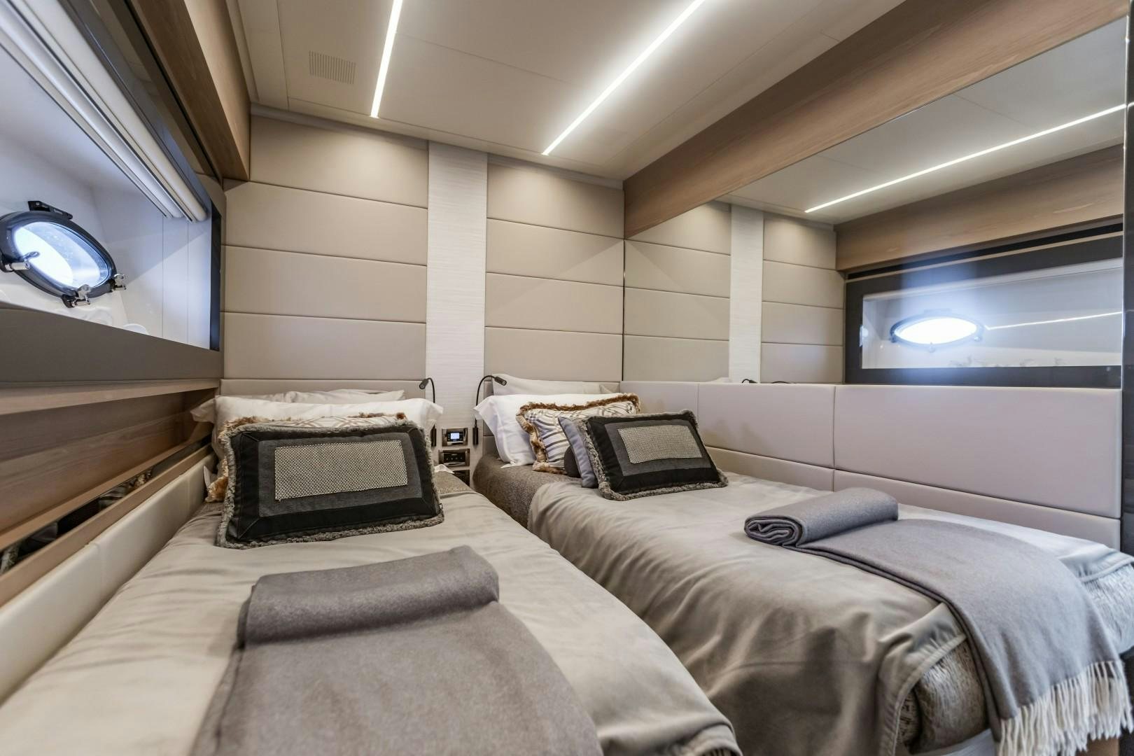 a room with two beds aboard Q80 Yacht for Sale