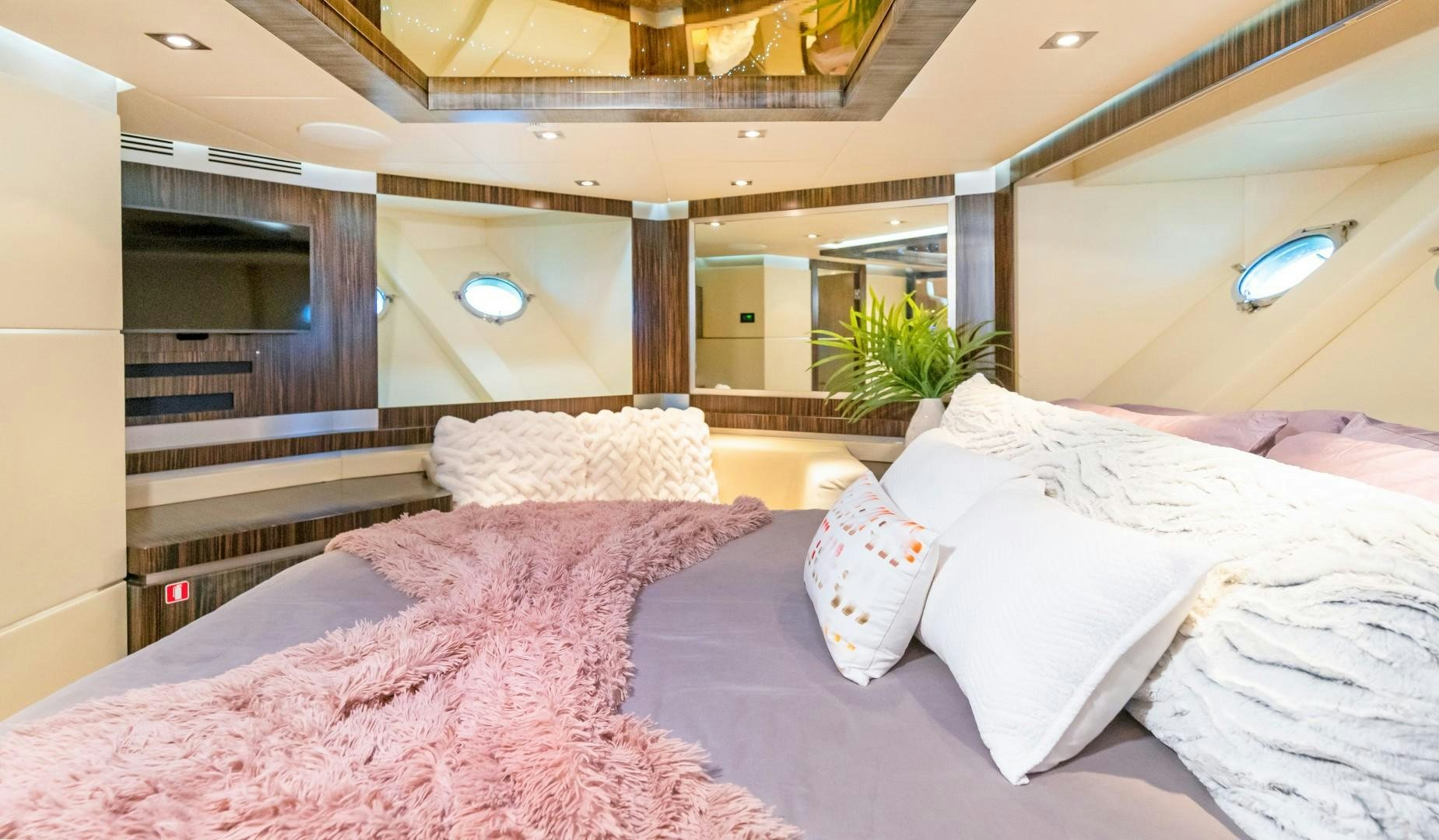 a room with beds and a plant aboard CASUAL Yacht for Sale