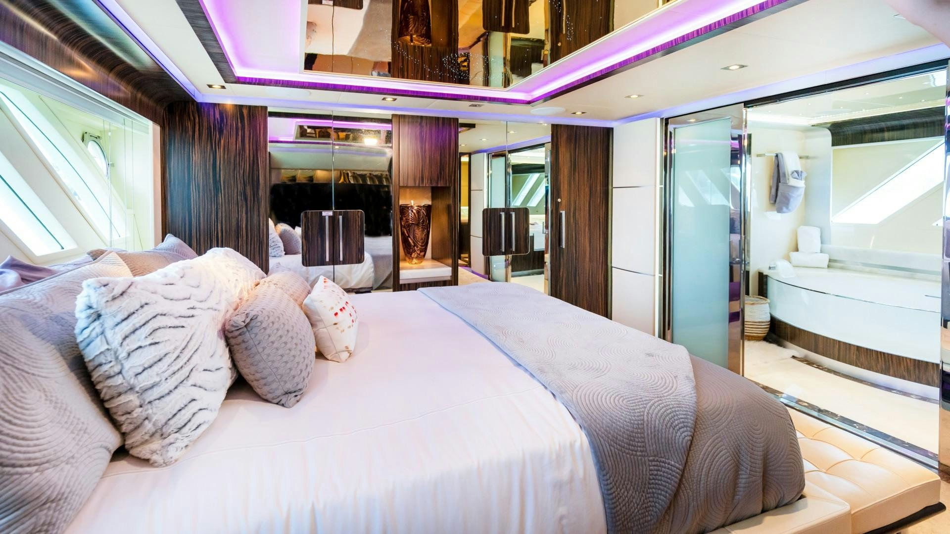 a bed with pillows and lights aboard CASUAL Yacht for Sale