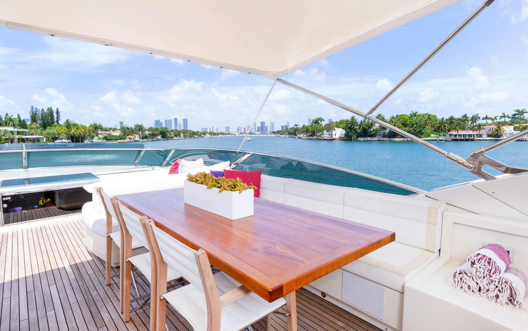 a table on a balcony overlooking a pool aboard CASUAL Yacht for Sale