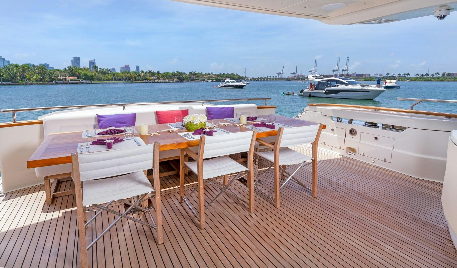 a table and chairs on a deck overlooking a body of water aboard CASUAL Yacht for Sale