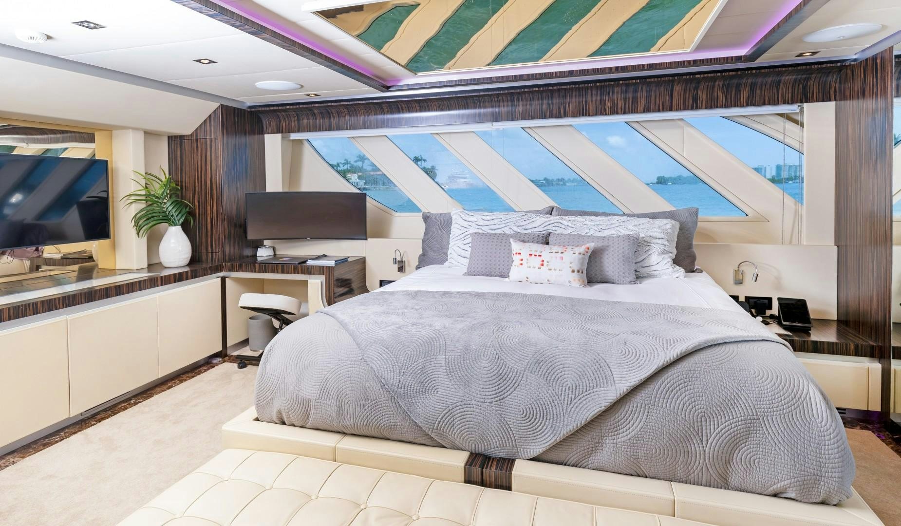 a bed with a blue and white bed spread aboard CASUAL Yacht for Sale