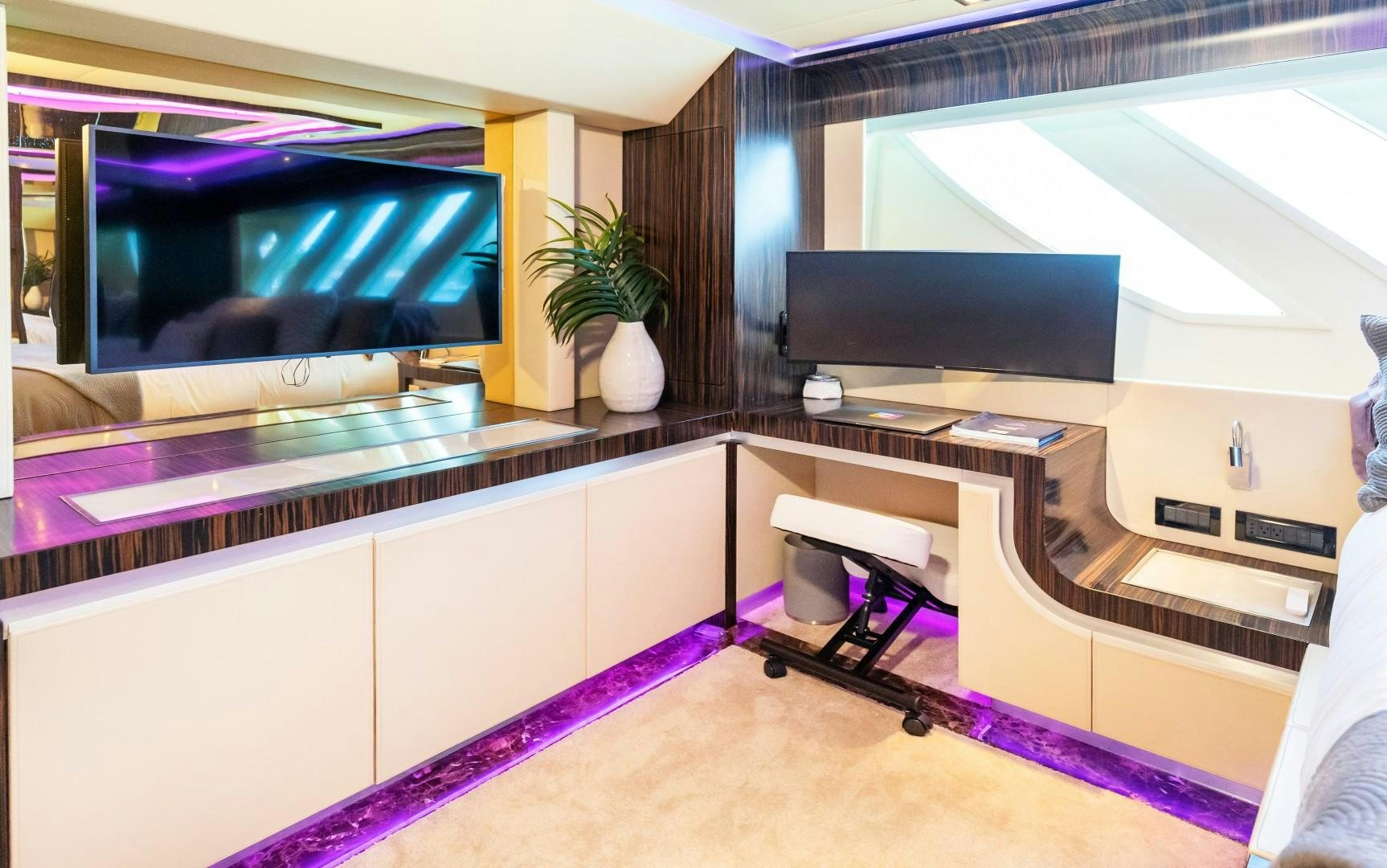 a room with a tv and a table aboard CASUAL Yacht for Sale