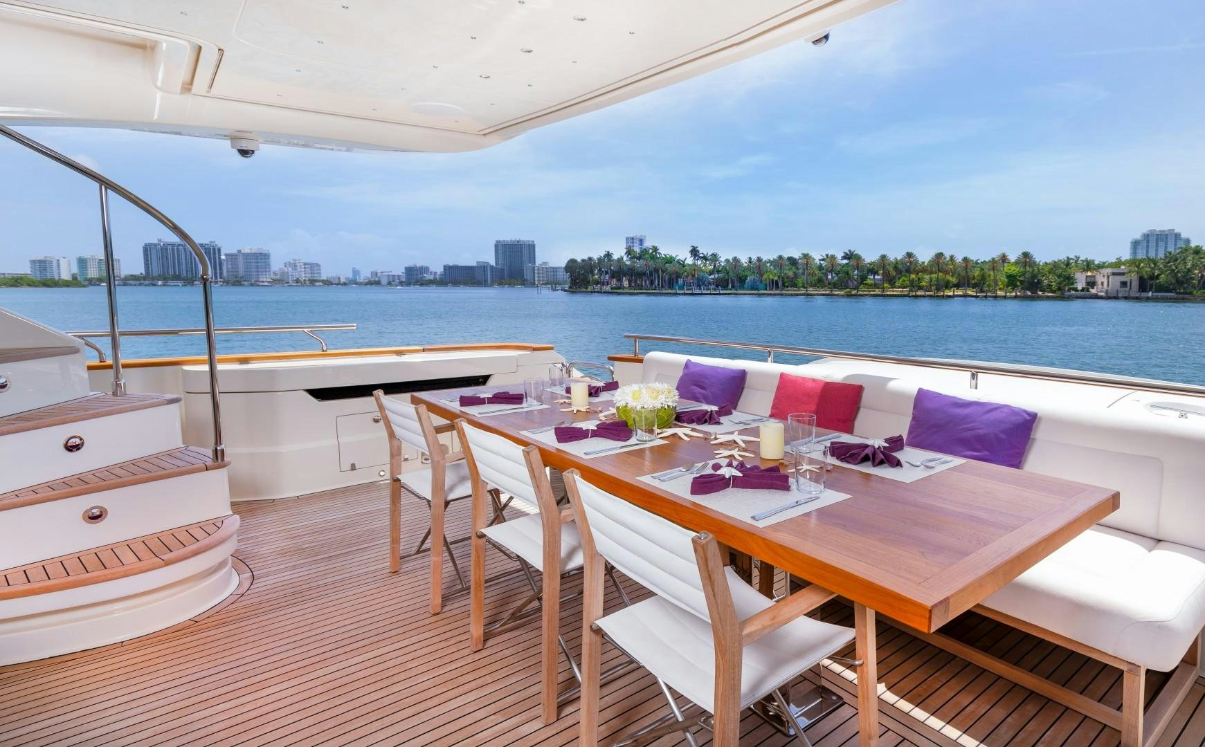 a table and chairs on a deck overlooking a body of water aboard CASUAL Yacht for Sale