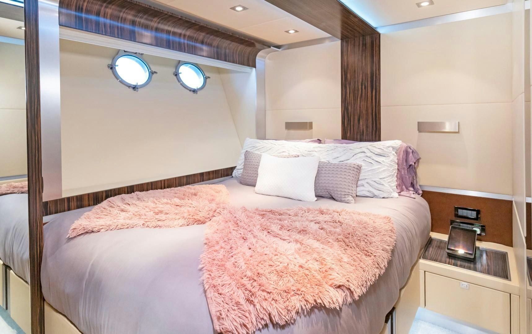 a bed with pink sheets aboard CASUAL Yacht for Sale