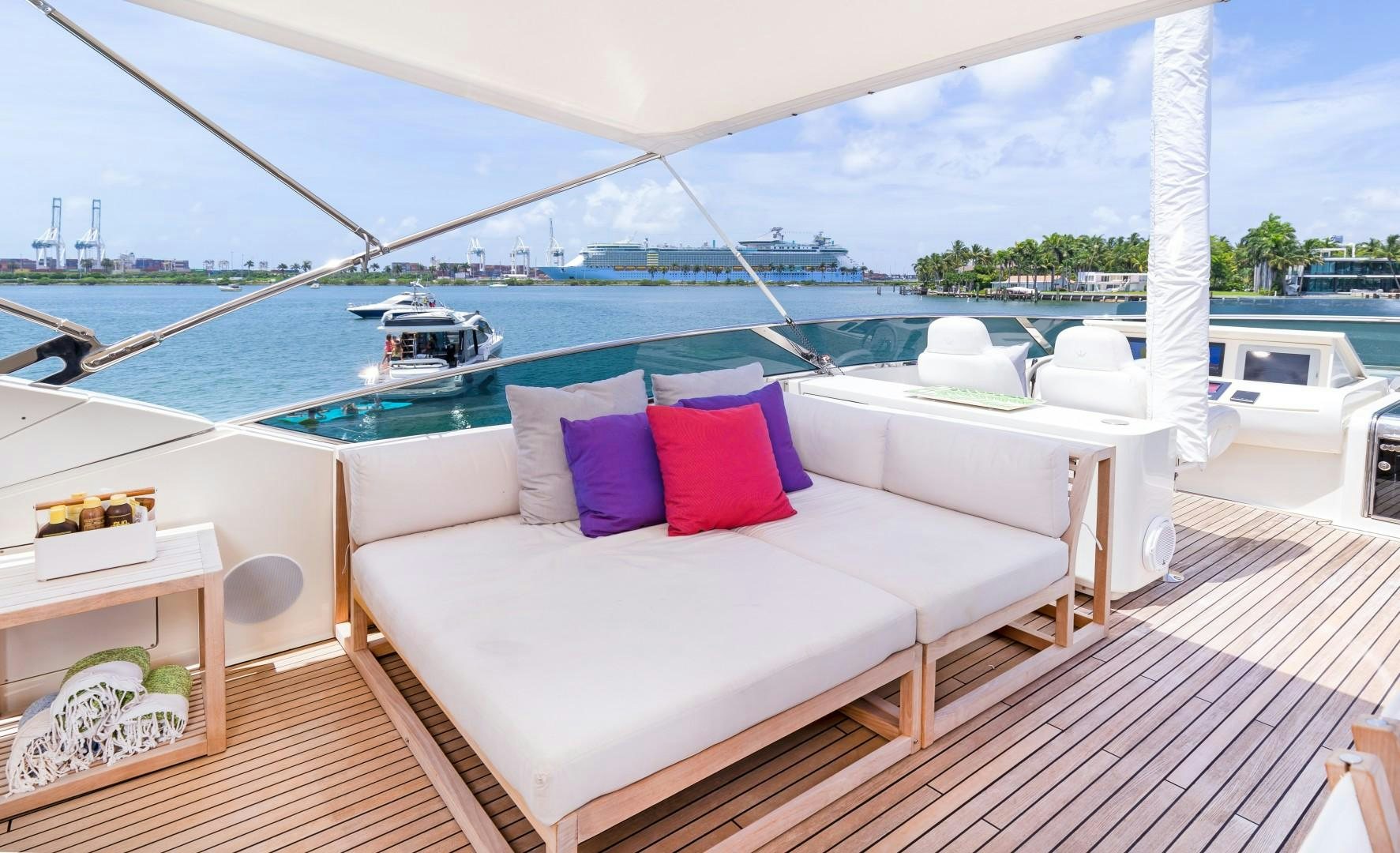 a white couch on a deck overlooking a body of water aboard CASUAL Yacht for Sale