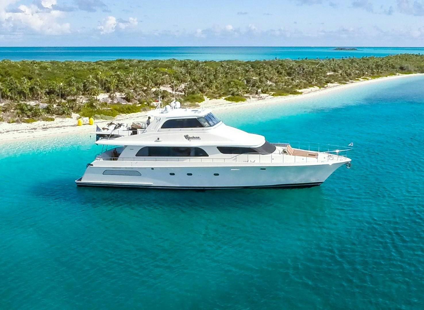 a white boat on a beach aboard EQUINOX X Yacht for Sale