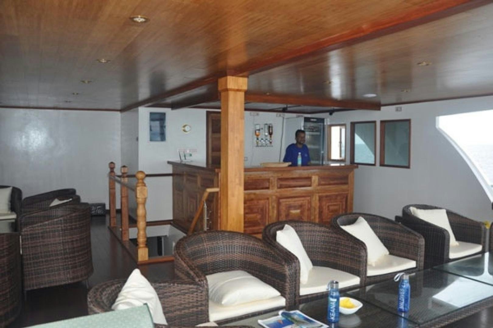a person sitting at a table aboard KEANA Yacht for Sale