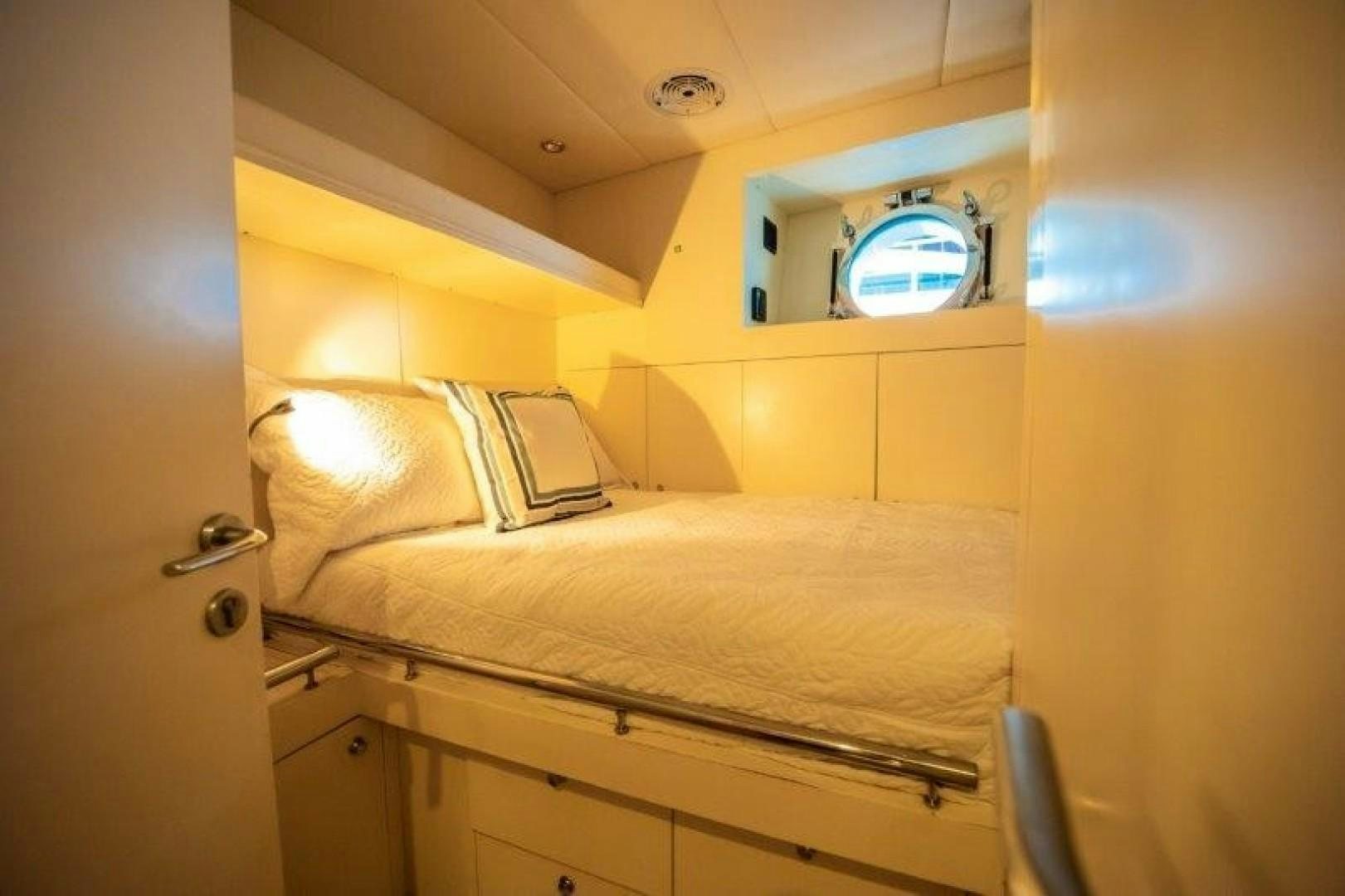 a room with a bed and a window aboard NYHAVEN Yacht for Sale