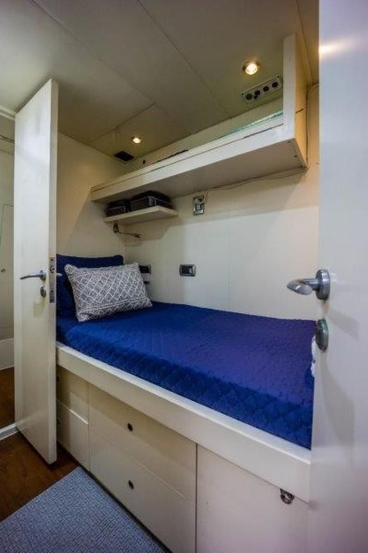 a bed with a blue sheet aboard NYHAVEN Yacht for Sale