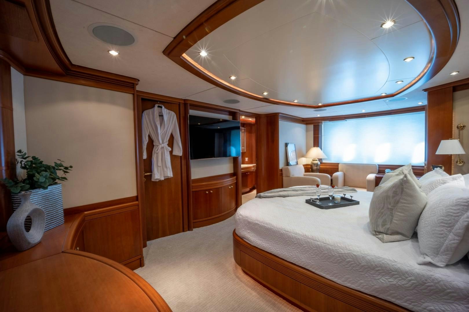 a hotel room with a bed and a large mirror aboard NYHAVEN Yacht for Sale