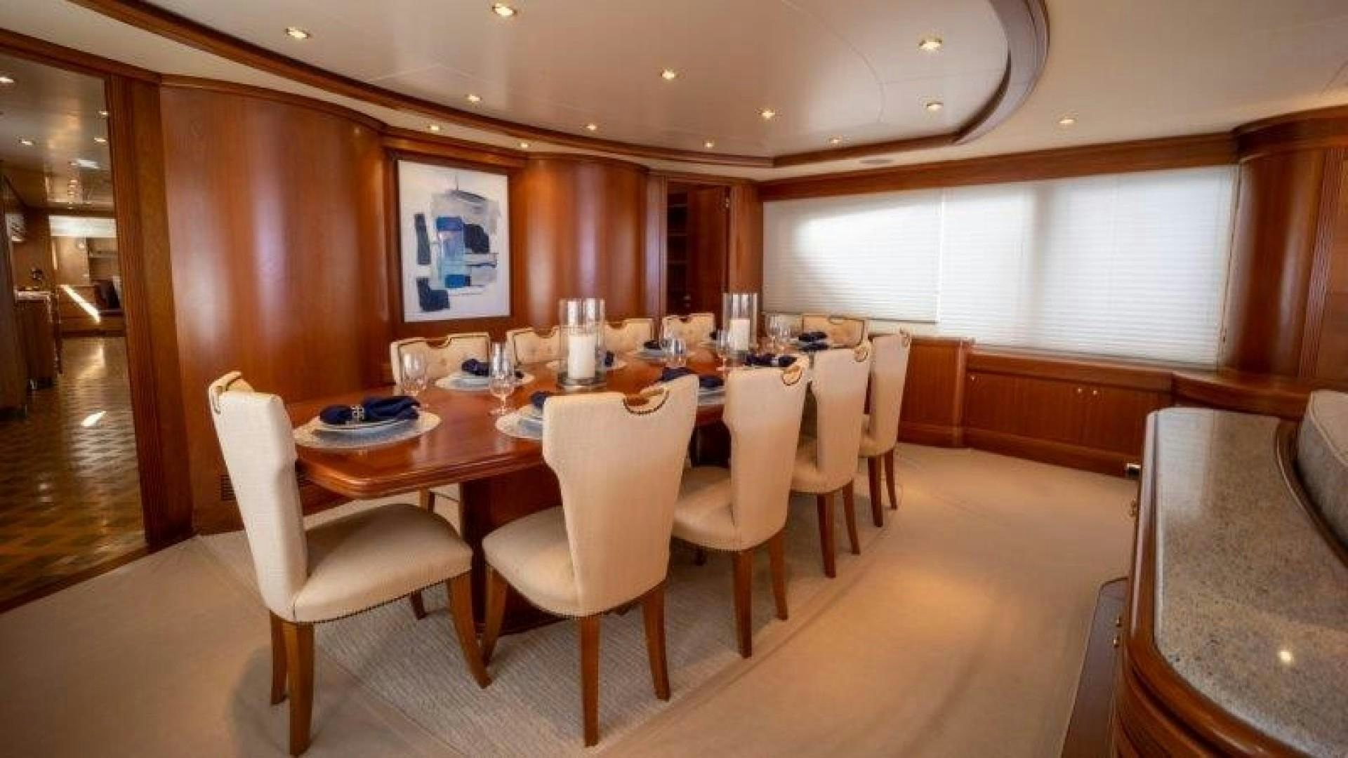 a dining room with a table and chairs aboard NYHAVEN Yacht for Sale