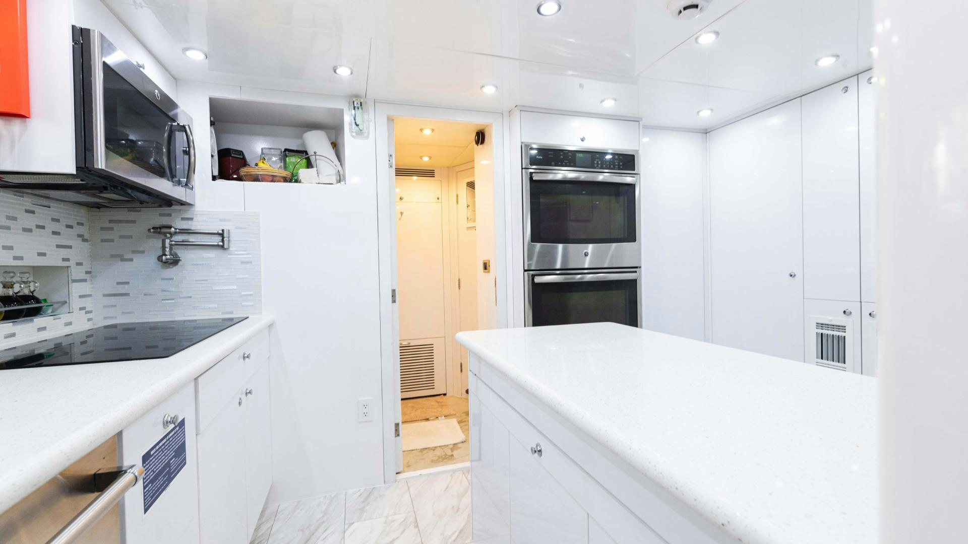 a kitchen with white cabinets aboard SEA ALICE I Yacht for Sale