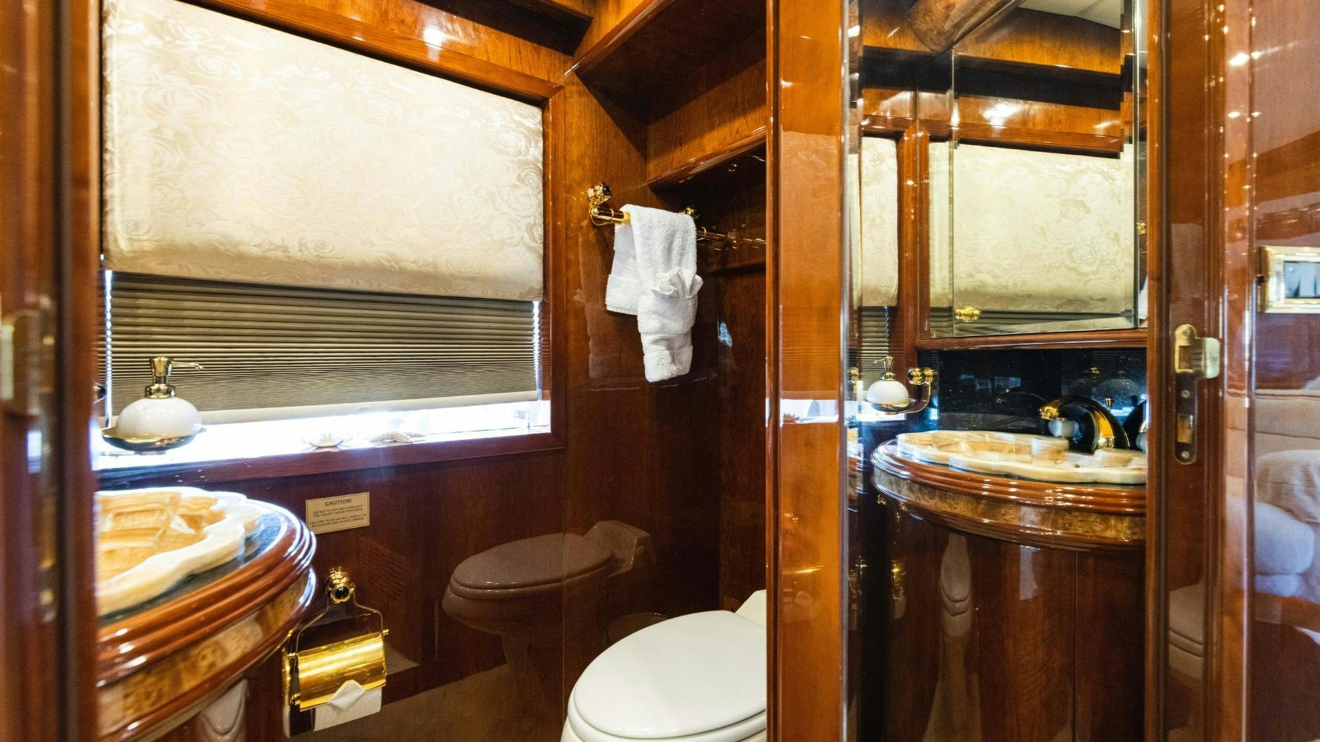 a bathroom with a toilet and sink aboard SEA ALICE I Yacht for Sale