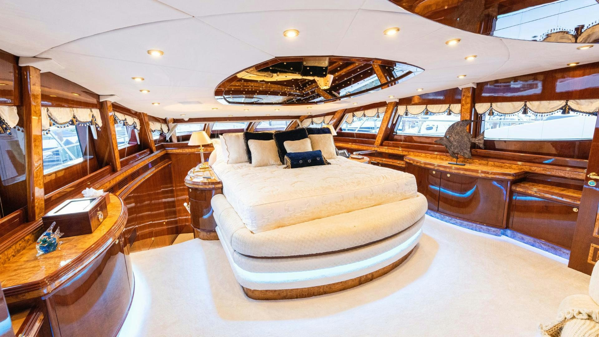 a large room with a bed and a table aboard SEA ALICE I Yacht for Sale
