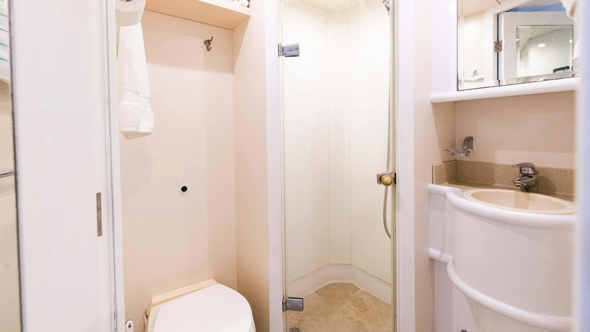 a bathroom with a sink and a toilet aboard SEA ALICE I Yacht for Sale