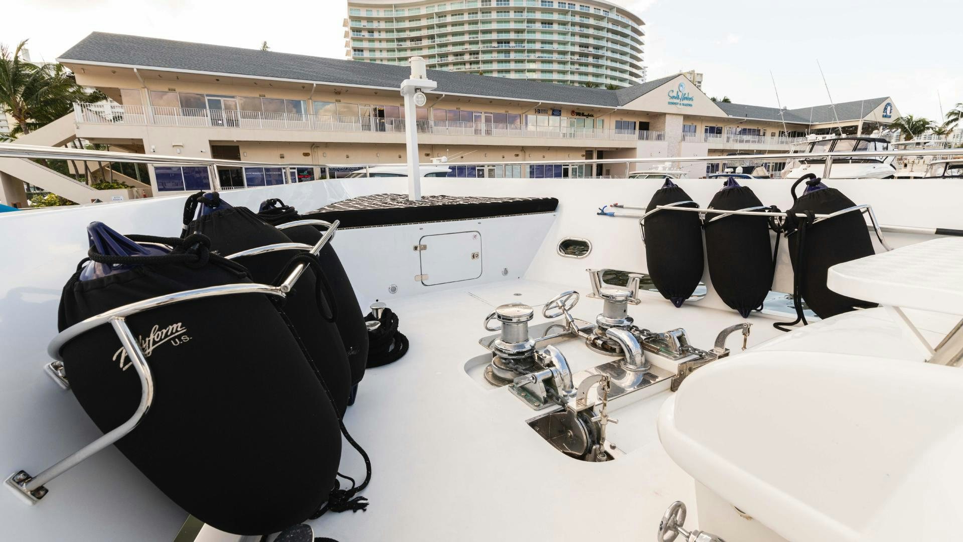 a pair of black sunglasses on a white surface with a building in the background aboard SEA ALICE I Yacht for Sale