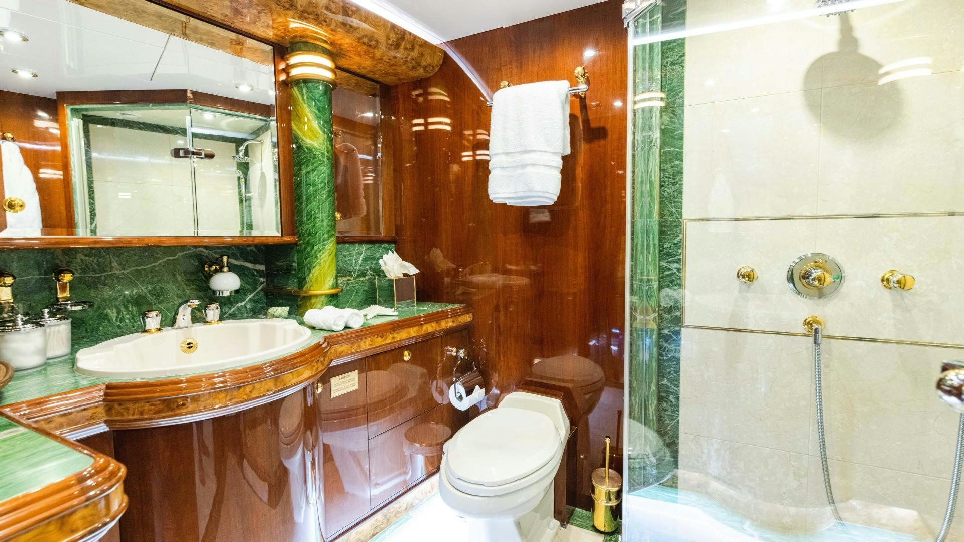 a bathroom with a sink toilet and bathtub aboard SEA ALICE I Yacht for Sale