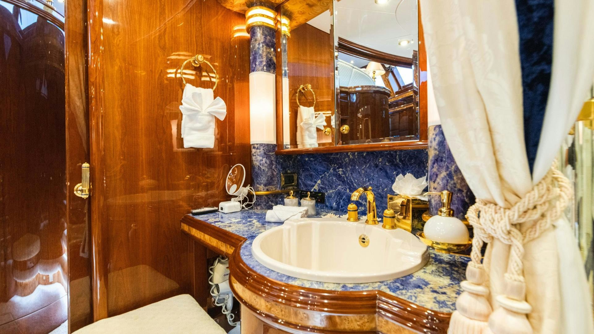 a bathroom with a sink and mirror aboard SEA ALICE I Yacht for Sale
