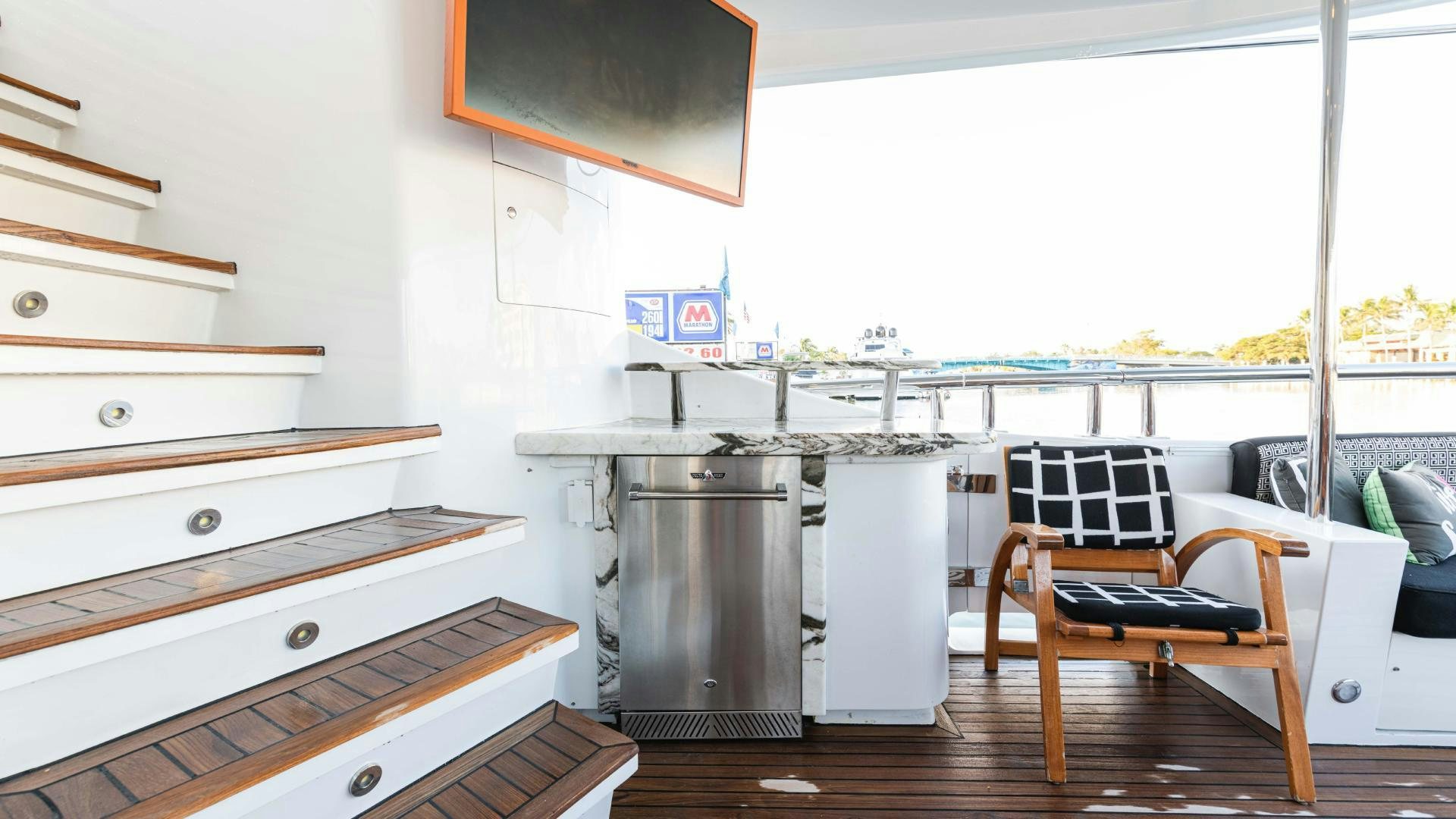 a kitchen with a stove and a chair aboard SEA ALICE I Yacht for Sale
