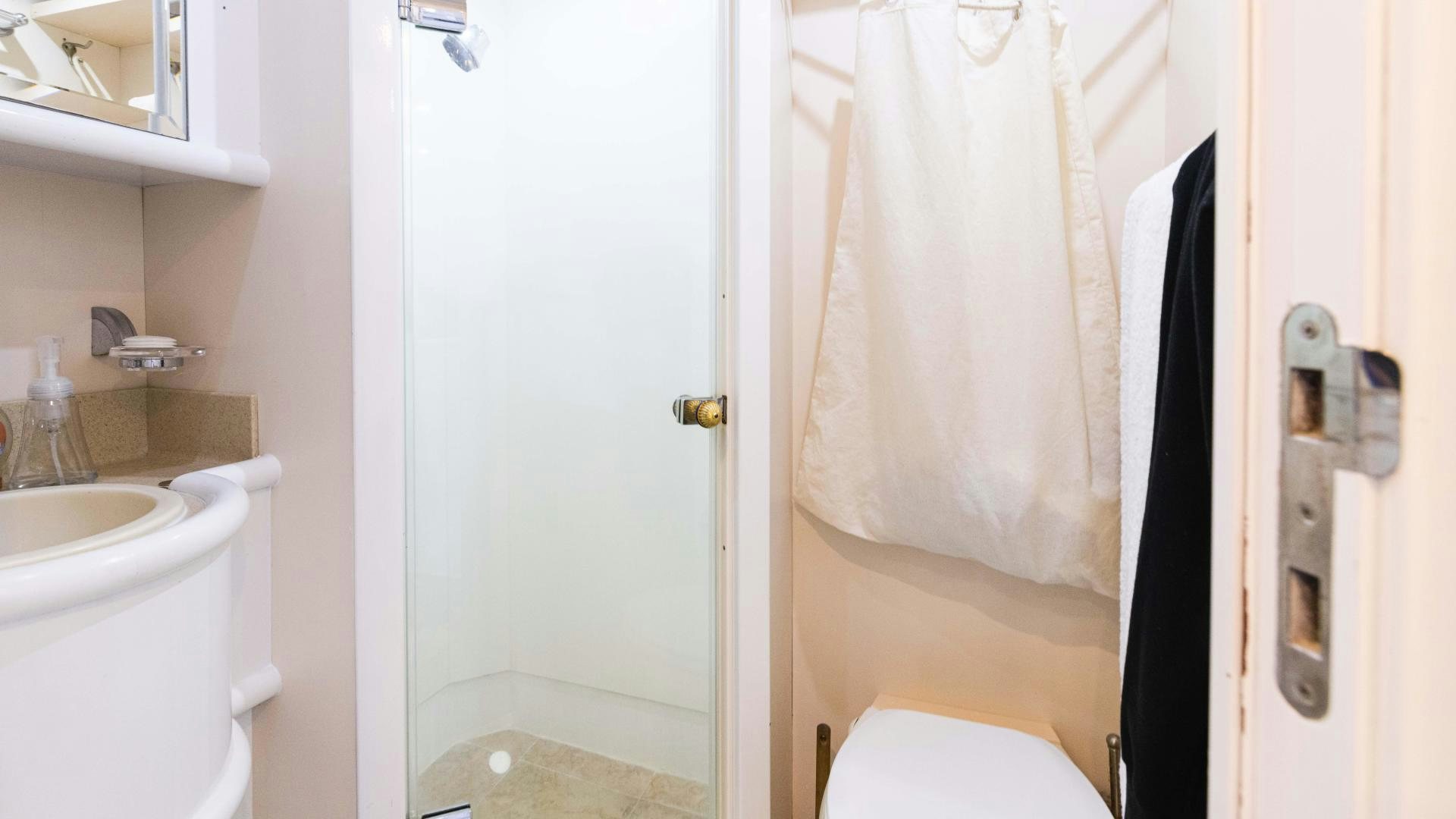 a bathroom with a toilet and sink aboard SEA ALICE I Yacht for Sale