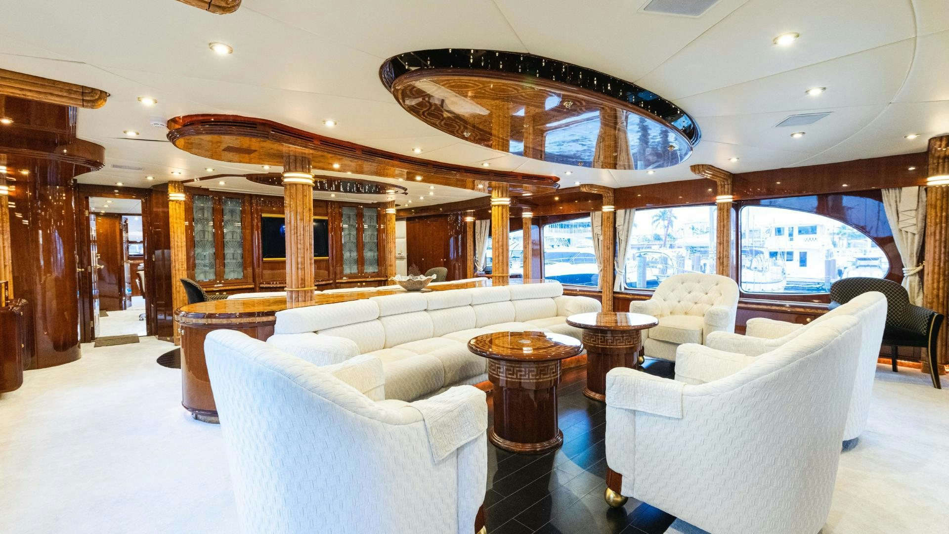 a large room with a large chandelier and a table aboard SEA ALICE I Yacht for Sale
