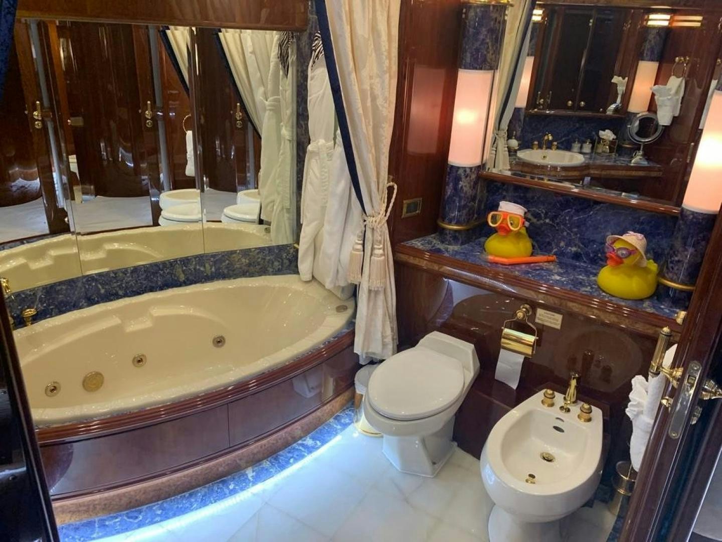 a bathroom with a tub sink and toilet aboard SEA ALICE I Yacht for Sale