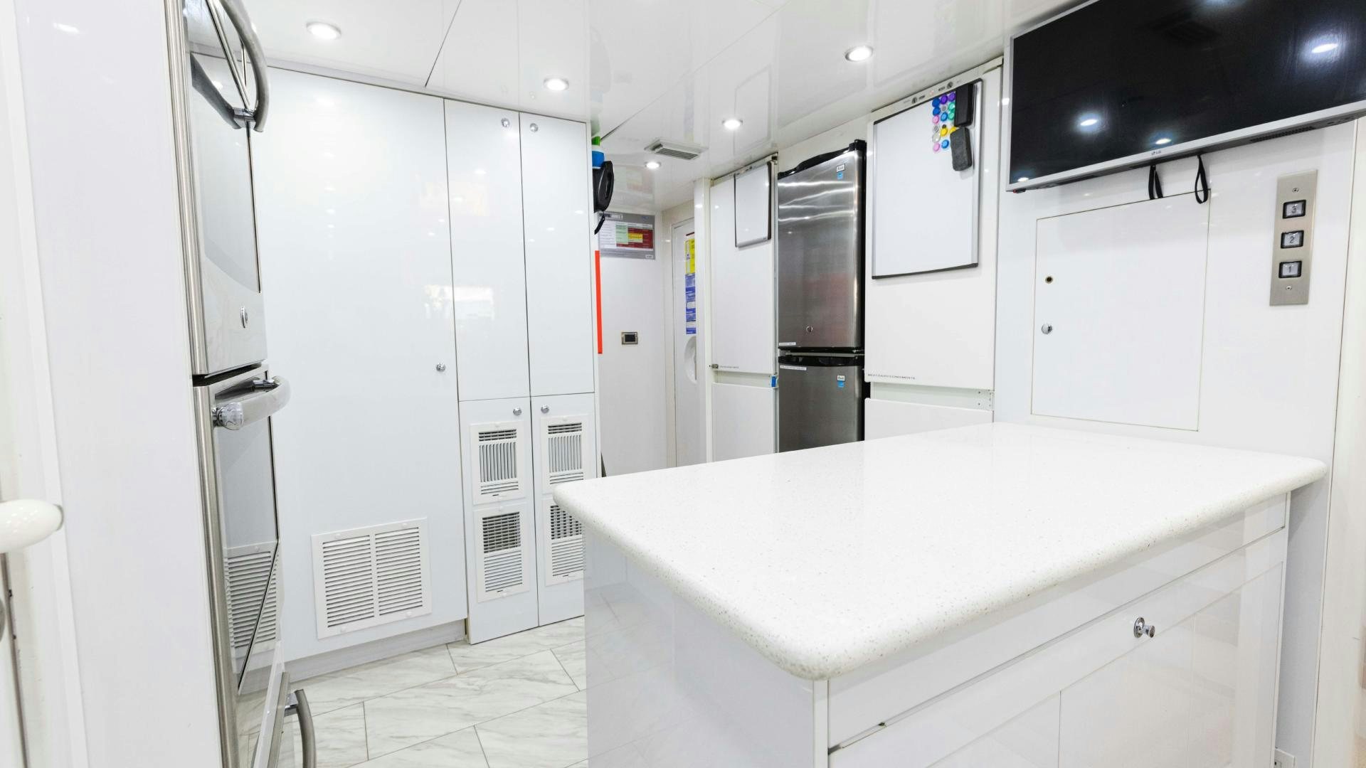 a kitchen with white cabinets aboard SEA ALICE I Yacht for Sale