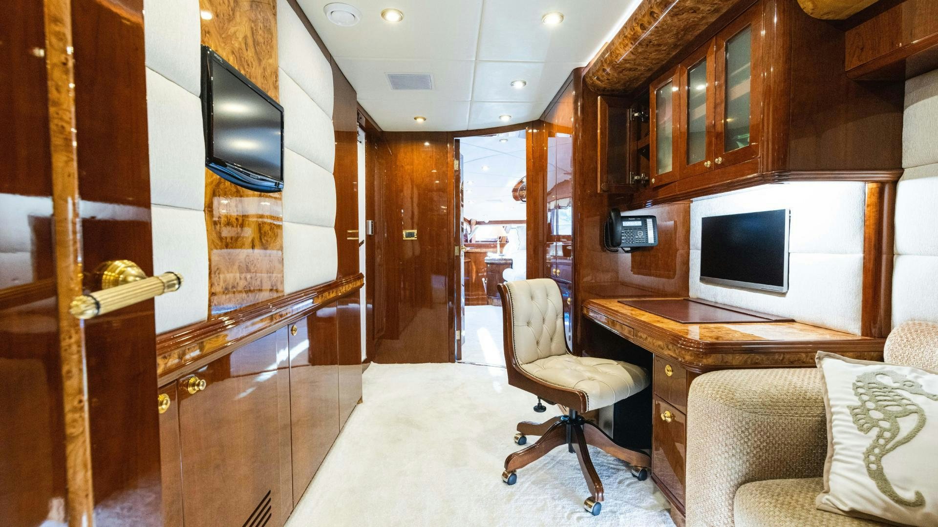 a living room with a tv and a chair aboard SEA ALICE I Yacht for Sale