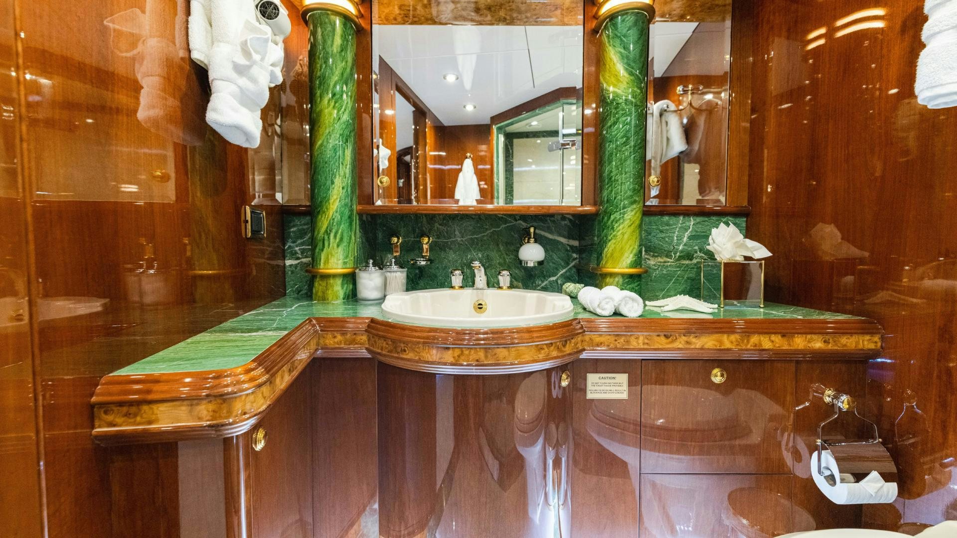 a bathroom with a sink and a large mirror aboard SEA ALICE I Yacht for Sale