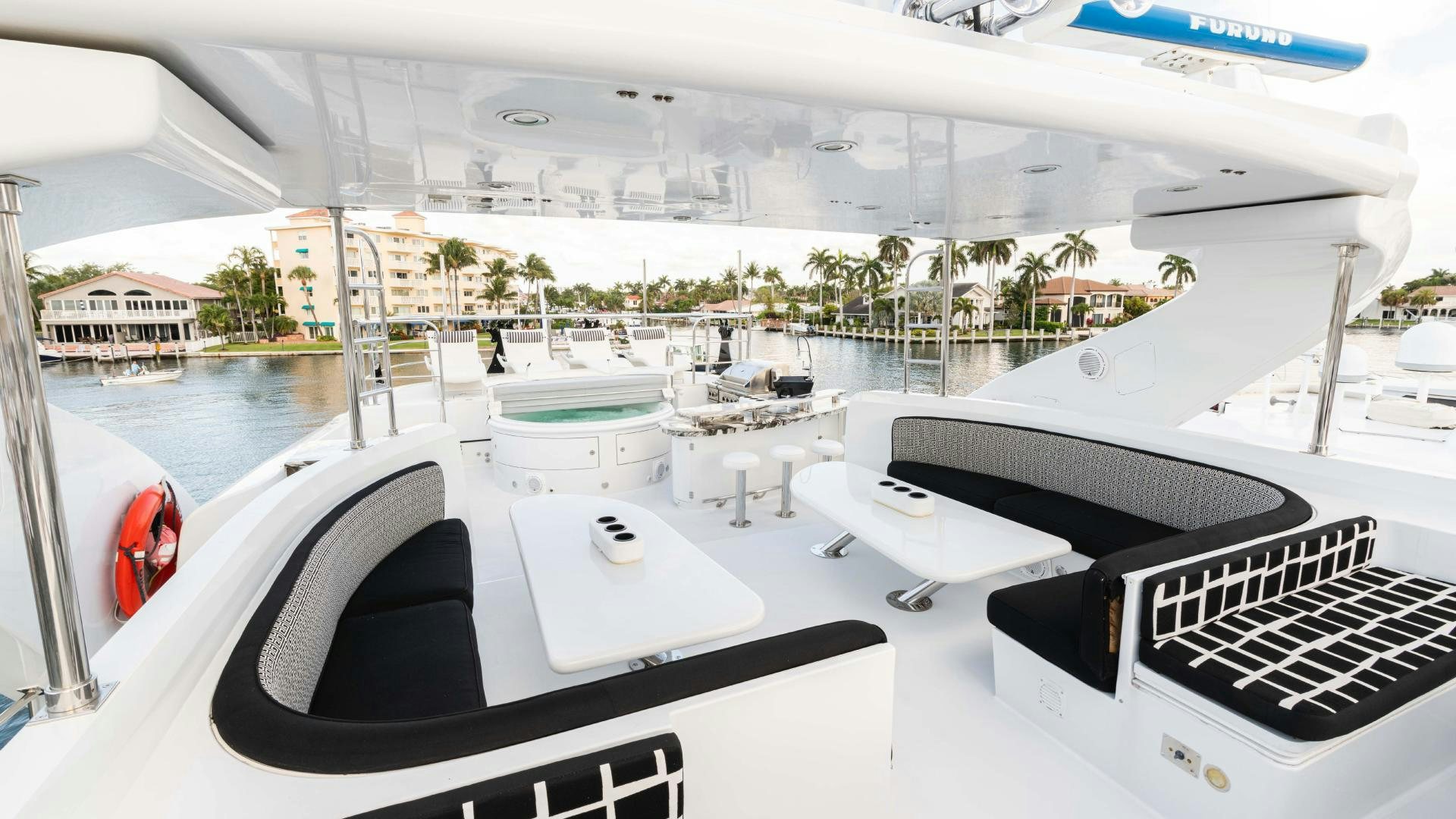 a boat with a white table and chairs on it aboard SEA ALICE I Yacht for Sale