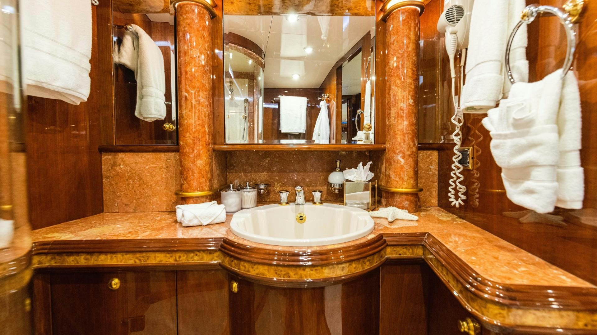 a bathroom with a sink and a mirror aboard SEA ALICE I Yacht for Sale