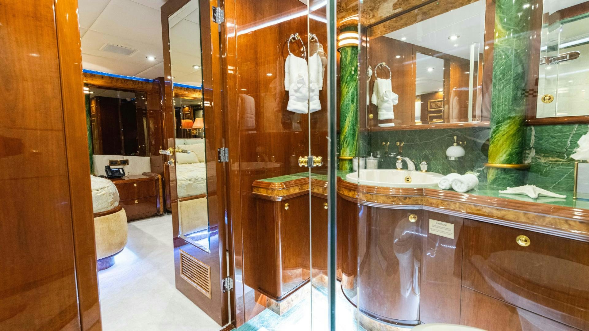 a bathroom with a glass shower aboard SEA ALICE I Yacht for Sale
