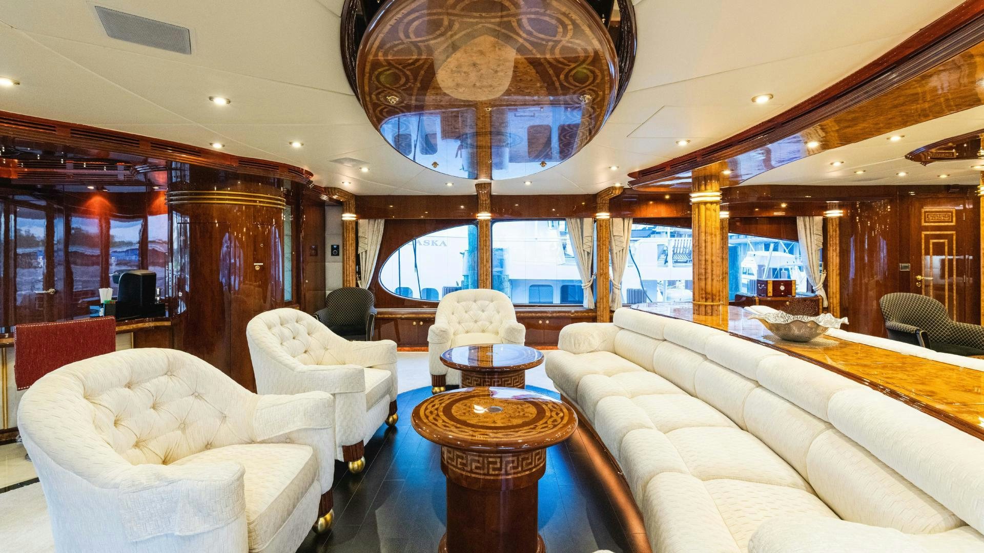 a room with a large chandelier and a round table aboard SEA ALICE I Yacht for Sale