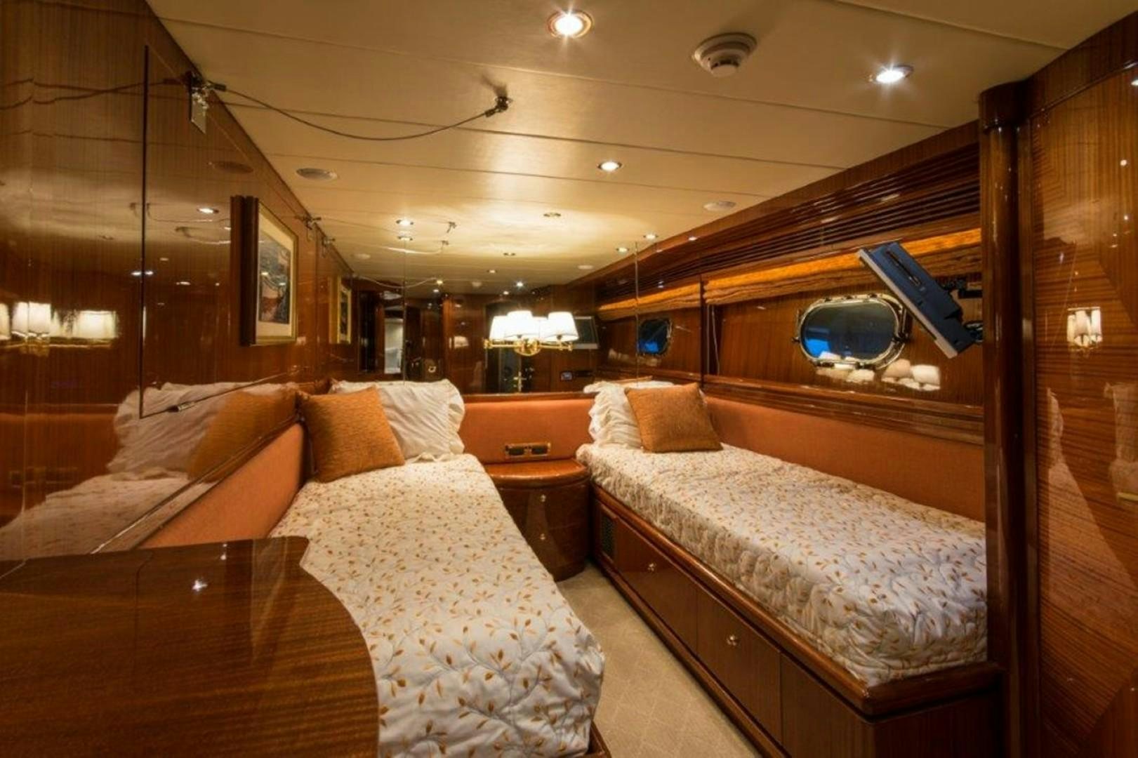 a room with a couple beds aboard MISS DUNIA Yacht for Sale