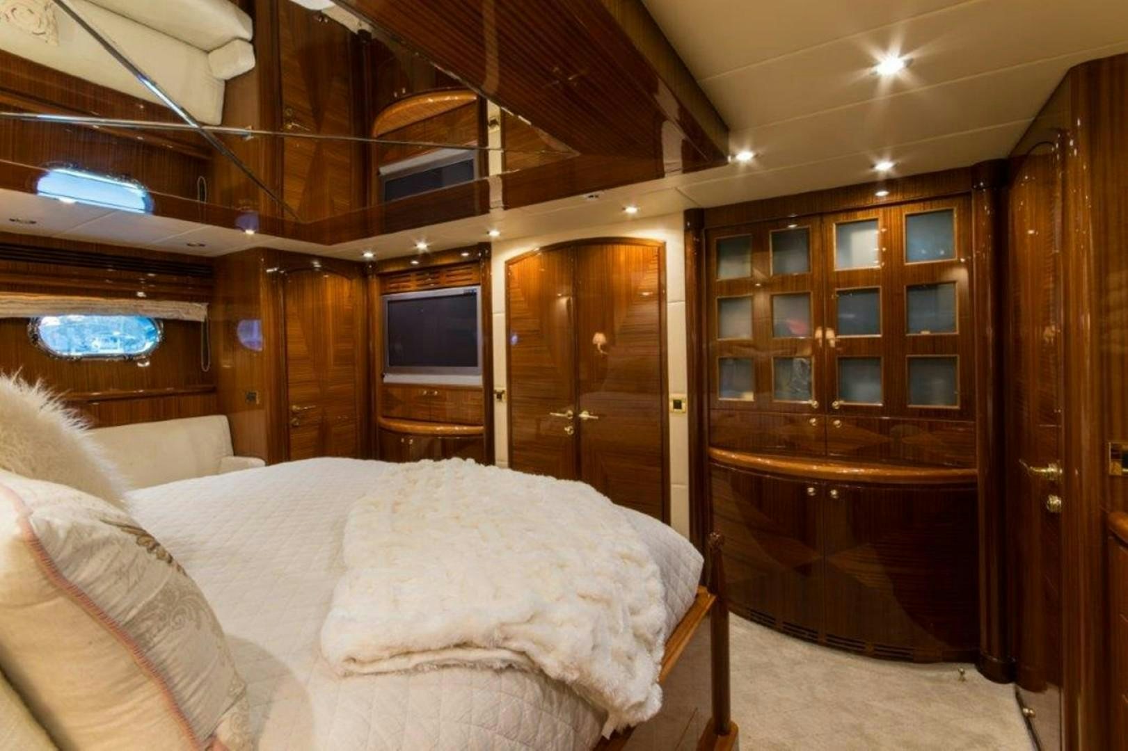 a room with a bed and a tv aboard MISS DUNIA Yacht for Sale