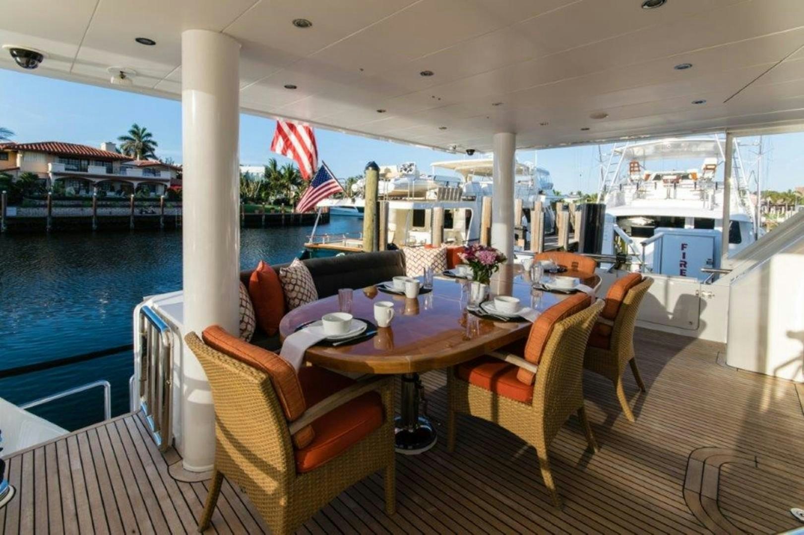 a boat with a table and chairs aboard MISS DUNIA Yacht for Sale