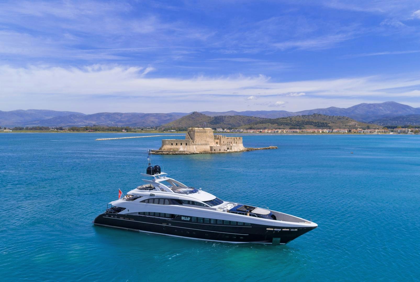 a boat in the water with a small island in the background aboard BLISS Yacht for Sale