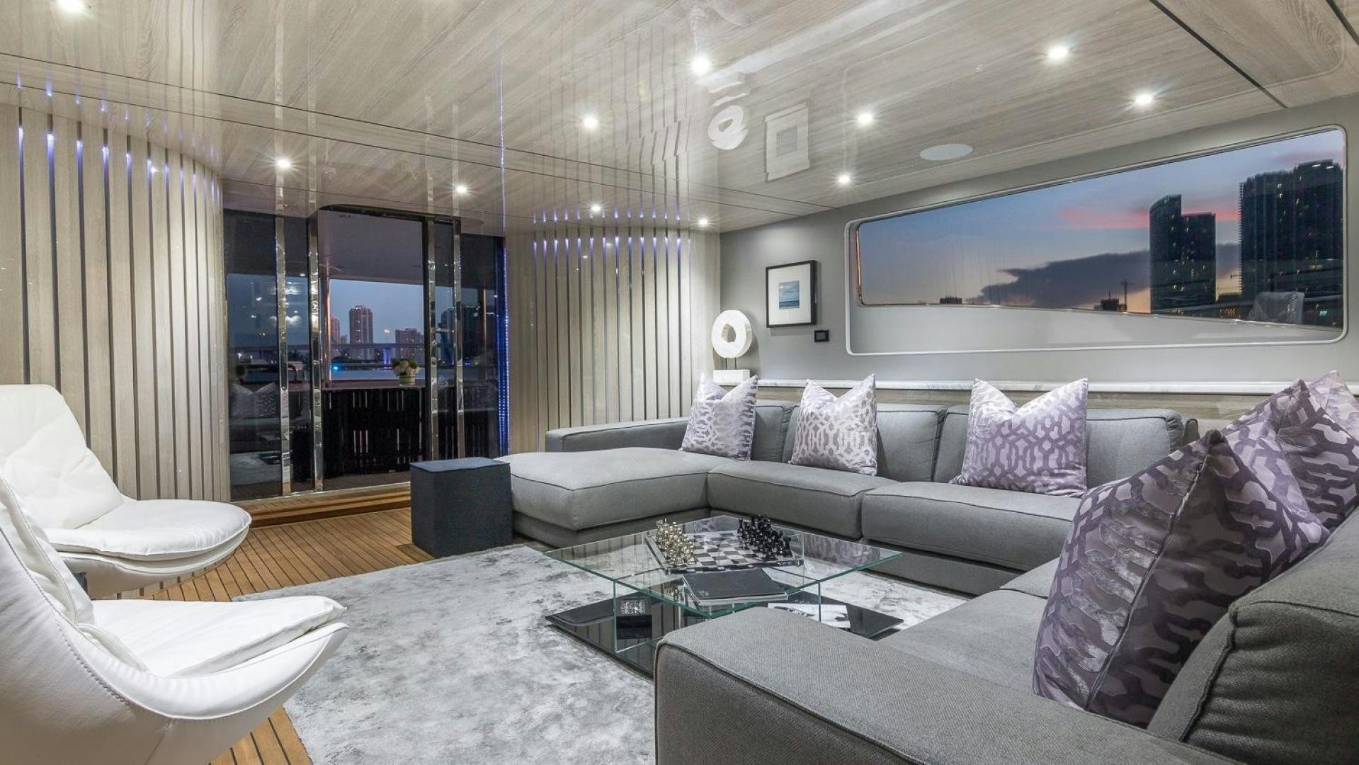 a living room with a large glass wall aboard NIRVANA Yacht for Sale