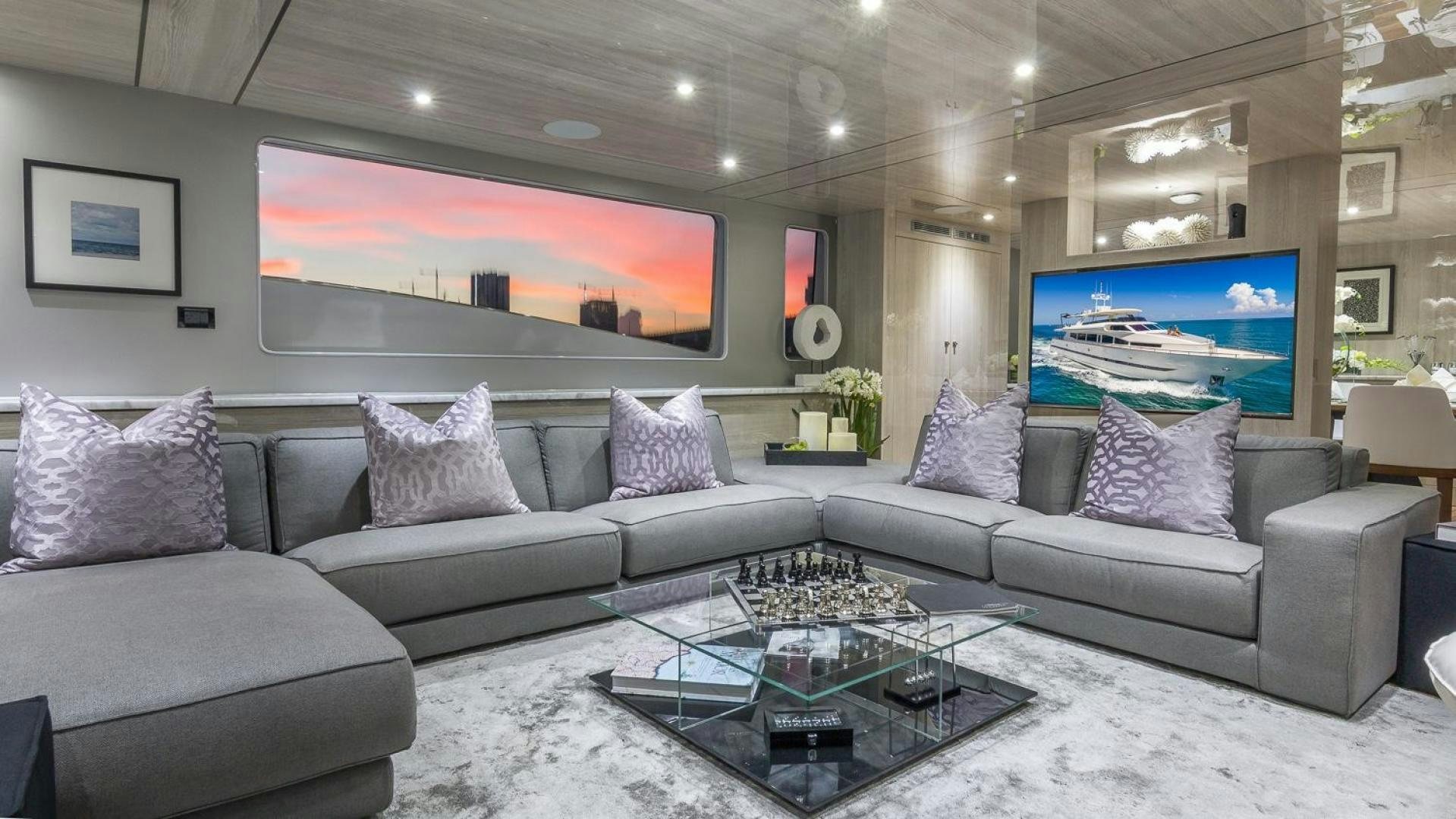 a living room with a large screen aboard NIRVANA Yacht for Sale