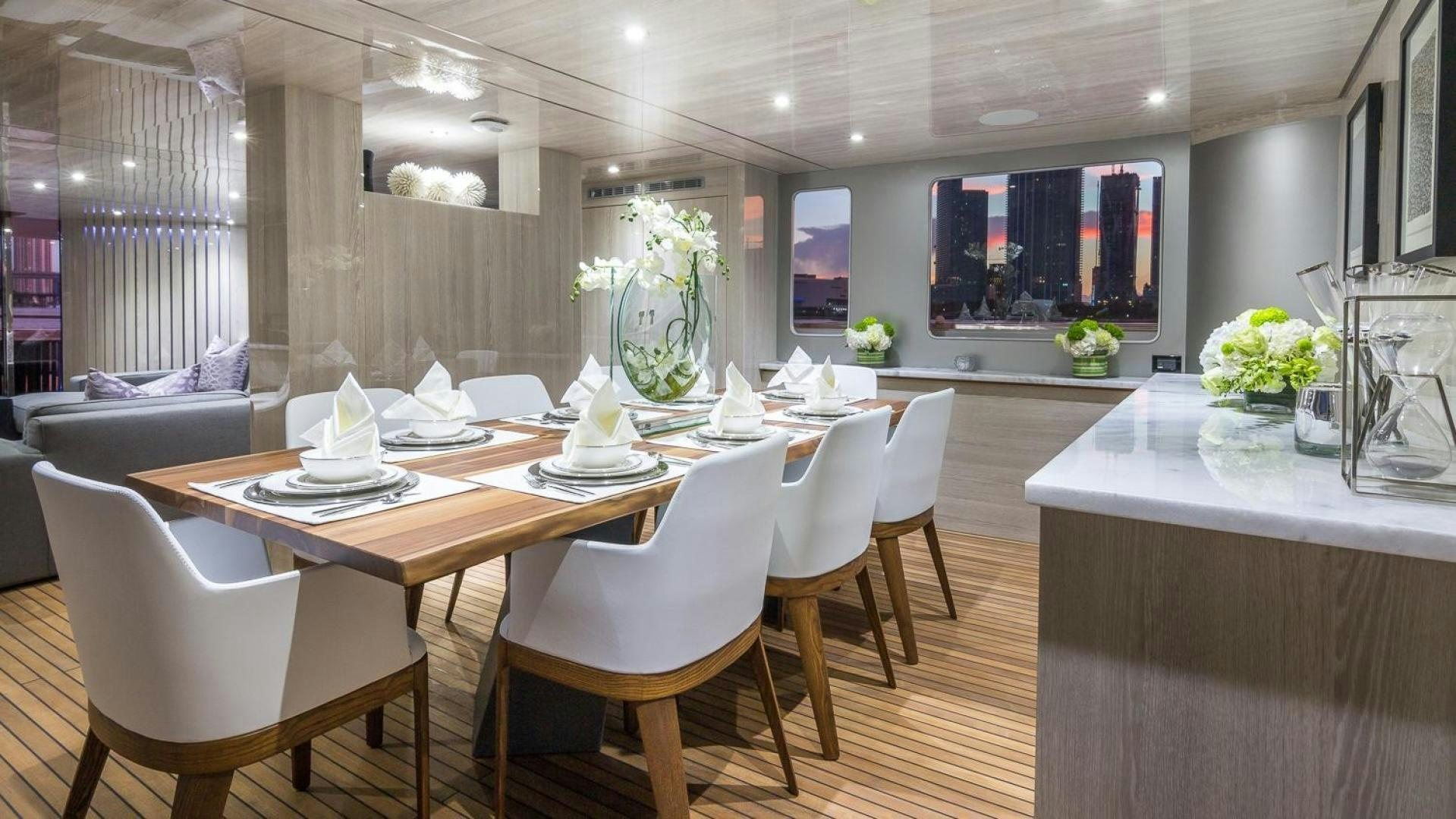 a large room with tables and chairs aboard NIRVANA Yacht for Sale