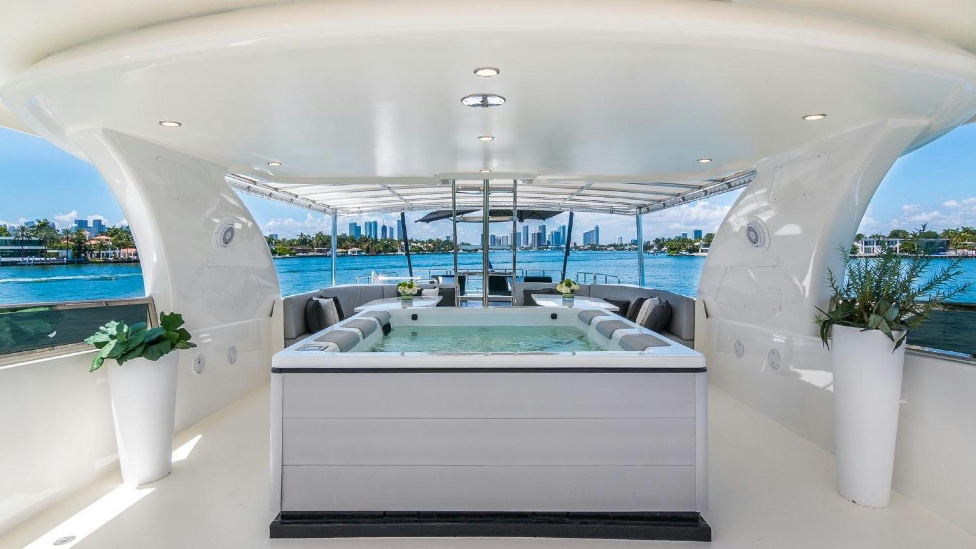 a large white lounge chair next to a pool and a large window aboard NIRVANA Yacht for Sale