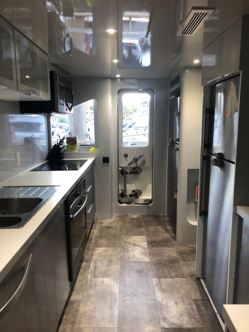 a kitchen with a large refrigerator aboard NIRVANA Yacht for Sale