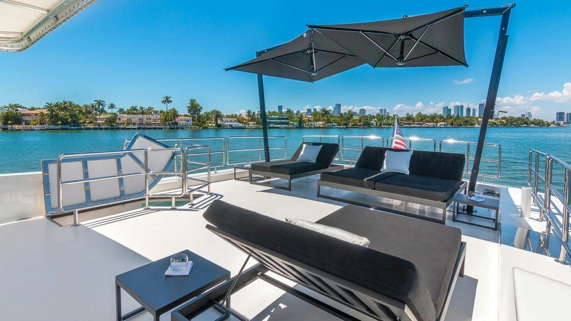 a deck with a view of a city and water aboard NIRVANA Yacht for Sale