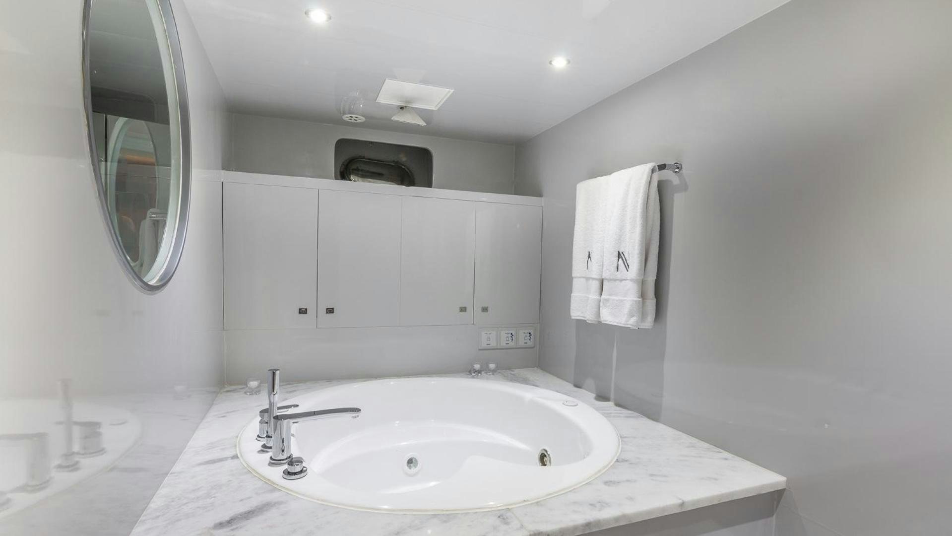 a bathroom with a sink and a mirror aboard NIRVANA Yacht for Sale